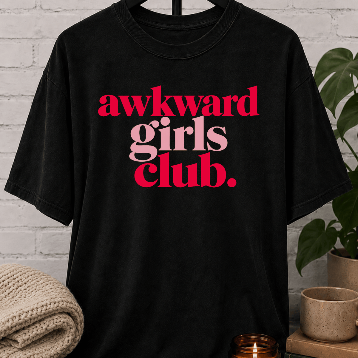 Socially awkward graphic T-shirt featuring the phrase “Awkward Girls Club” in bold retro lettering, an awkward humor shirt for women, shy personalities, and socially clumsy girls.