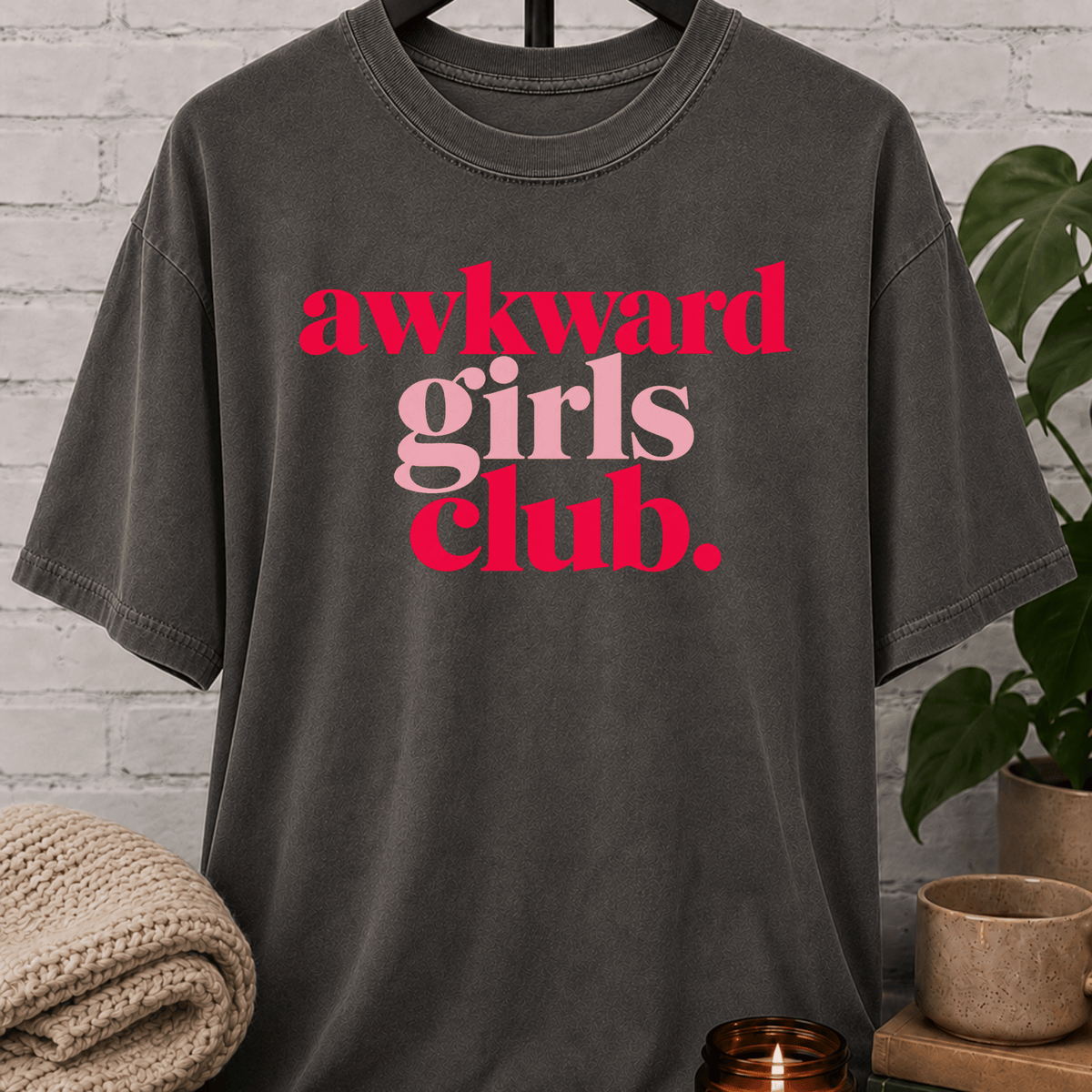 Socially awkward graphic T-shirt featuring the phrase “Awkward Girls Club” in bold retro lettering, an awkward humor shirt for women, shy personalities, and socially clumsy girls.
