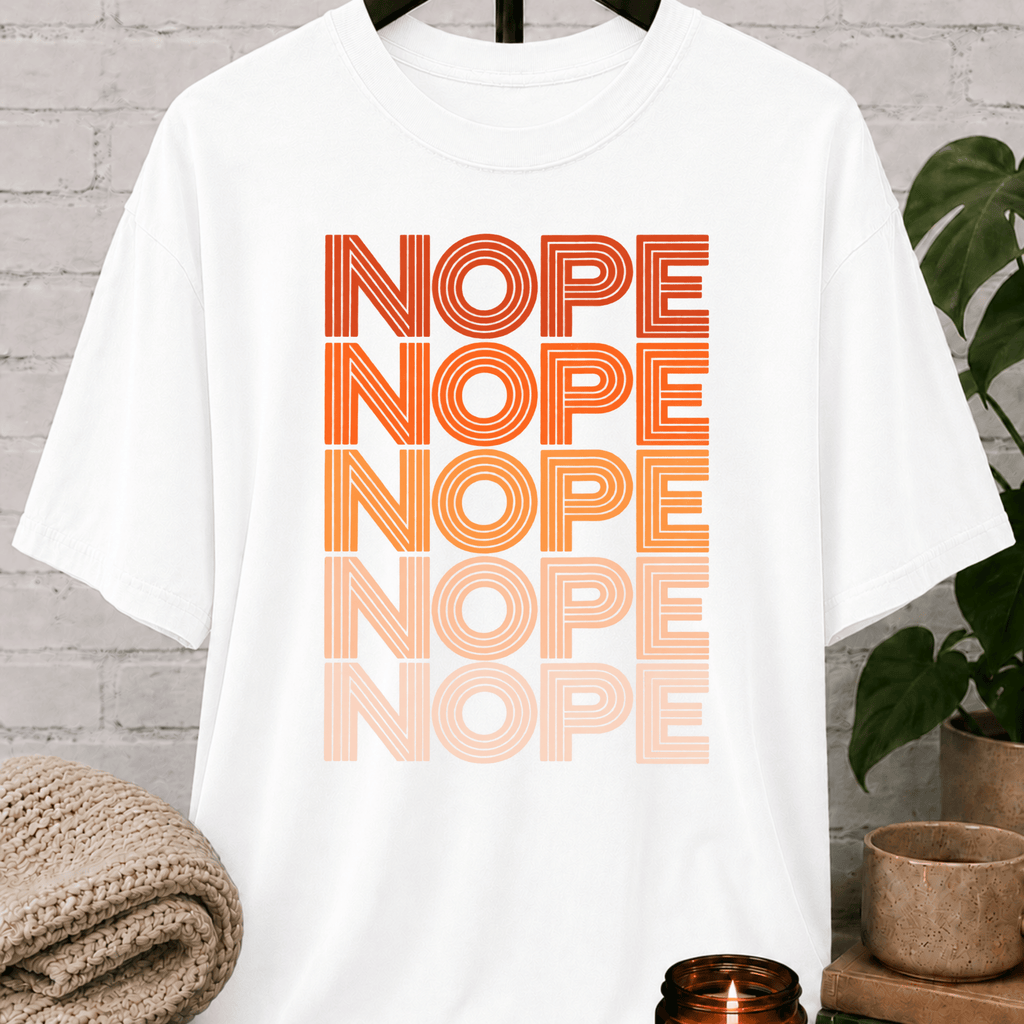 Socially selective graphic T-shirt featuring the word “NOPE” repeated five times in retro stacked lettering, a bold refusal humor shirt for plan avoiders, low social battery days, and people who prefer opting out.