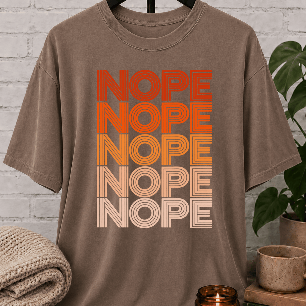 Socially selective graphic T-shirt featuring the word “NOPE” repeated five times in retro stacked lettering, a bold refusal humor shirt for plan avoiders, low social battery days, and people who prefer opting out.