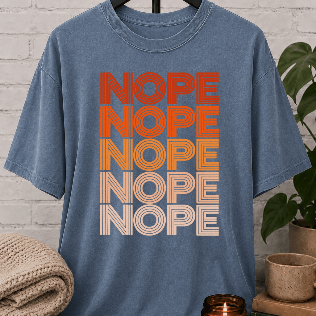 Socially selective graphic T-shirt featuring the word “NOPE” repeated five times in retro stacked lettering, a bold refusal humor shirt for plan avoiders, low social battery days, and people who prefer opting out.
