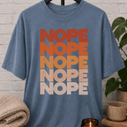 Socially selective graphic T-shirt featuring the word “NOPE” repeated five times in retro stacked lettering, a bold refusal humor shirt for plan avoiders, low social battery days, and people who prefer opting out.