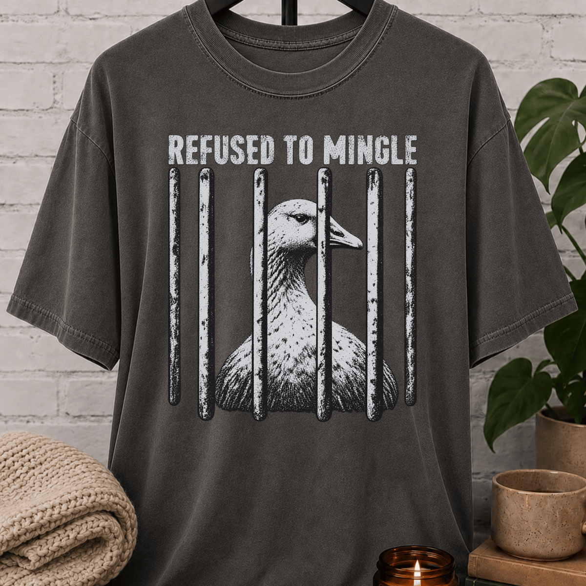 Antisocial goose graphic T-shirt featuring a goose behind jail bars with the phrase “Refused to Mingle,” a crowd-avoidance shirt for reluctant socializers, loners, and people who prefer minimal interaction.