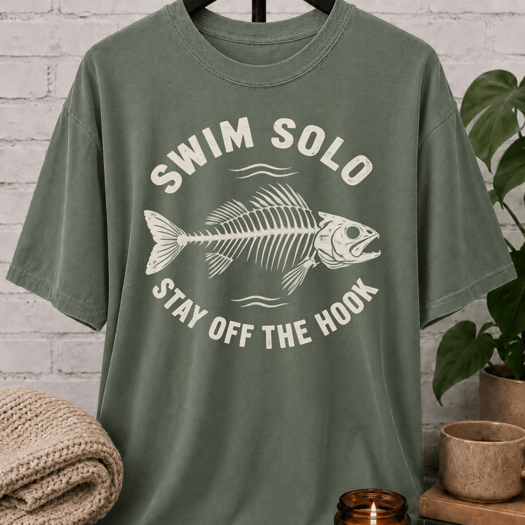 Loner fish graphic T-shirt featuring a fish skeleton with the phrase “Swim Solo Stay Off the Hook,” a sarcastic solo-life shirt for independent people, solitude lovers, and fans of people-avoidance humor.