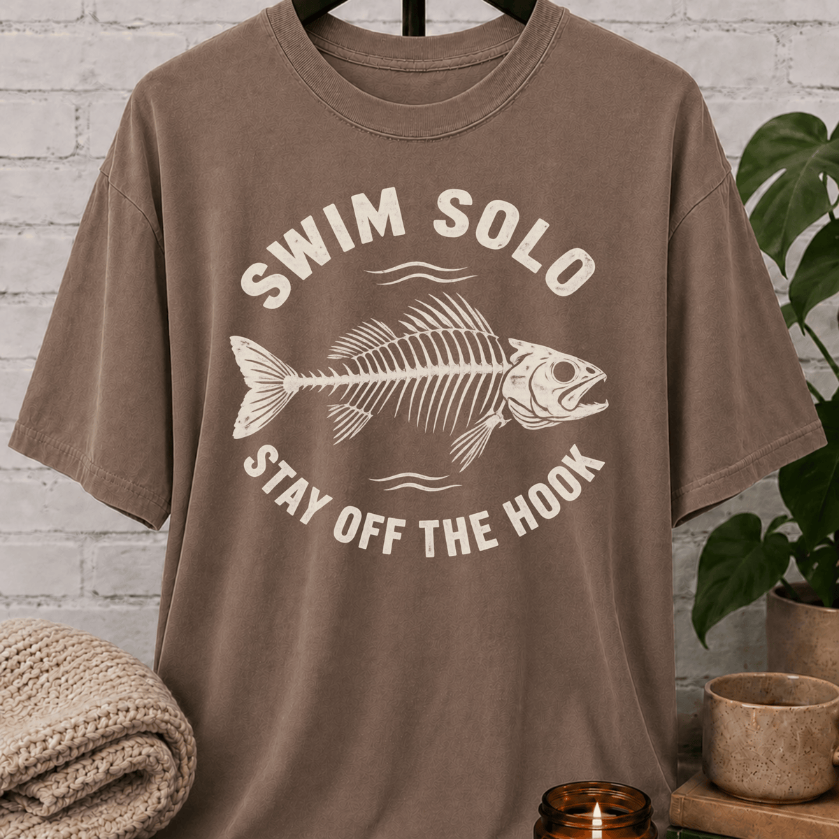 Loner fish graphic T-shirt featuring a fish skeleton with the phrase “Swim Solo Stay Off the Hook,” a sarcastic solo-life shirt for independent people, solitude lovers, and fans of people-avoidance humor.
