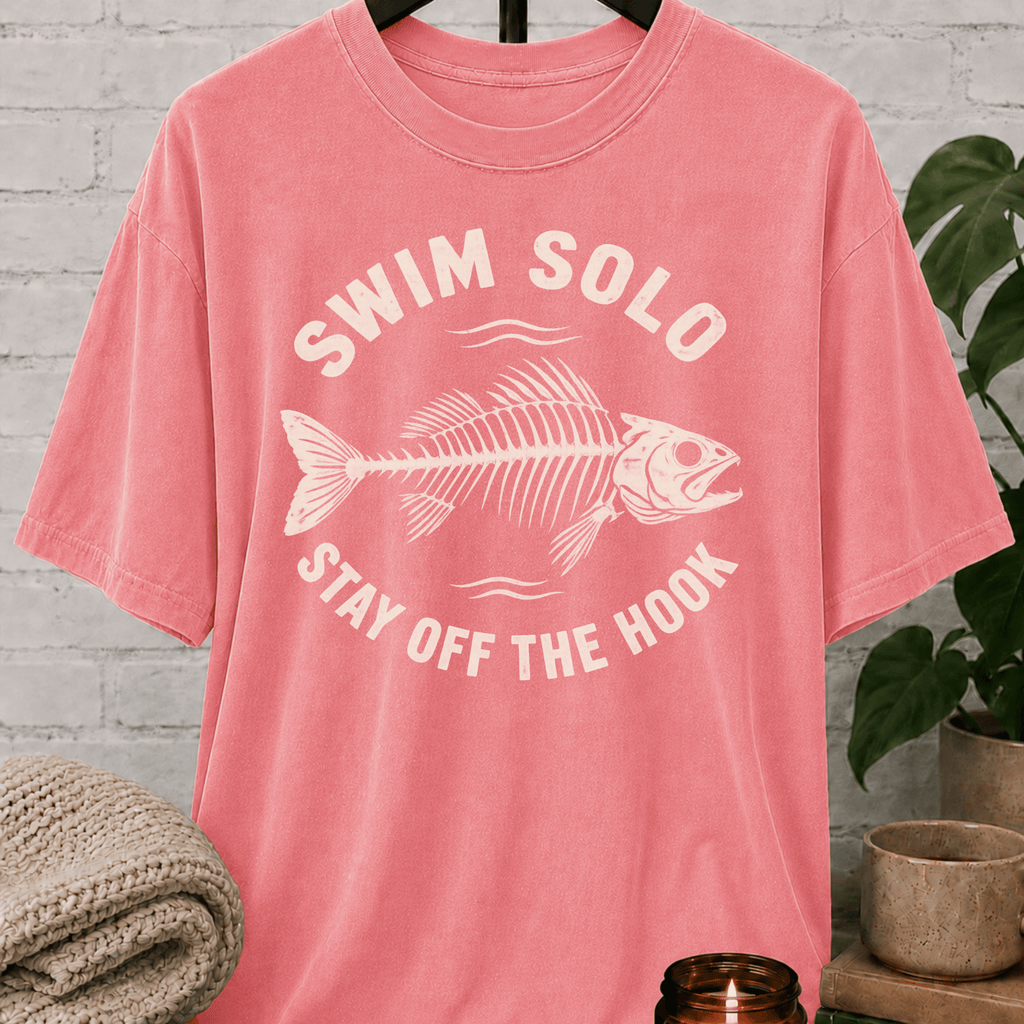 Loner fish graphic T-shirt featuring a fish skeleton with the phrase “Swim Solo Stay Off the Hook,” a sarcastic solo-life shirt for independent people, solitude lovers, and fans of people-avoidance humor.