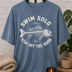 Loner fish graphic T-shirt featuring a fish skeleton with the phrase “Swim Solo Stay Off the Hook,” a sarcastic solo-life shirt for independent people, solitude lovers, and fans of people-avoidance humor.