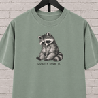 Quietly Over It raccoon graphic T-shirt featuring a tired raccoon, a low social battery shirt for socially drained people and introvert humor fans.