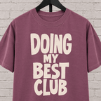 Doing My Best Club graphic T-shirt featuring bold stacked lettering, a low energy humor shirt for overwhelmed days and people running on limited bandwidth.