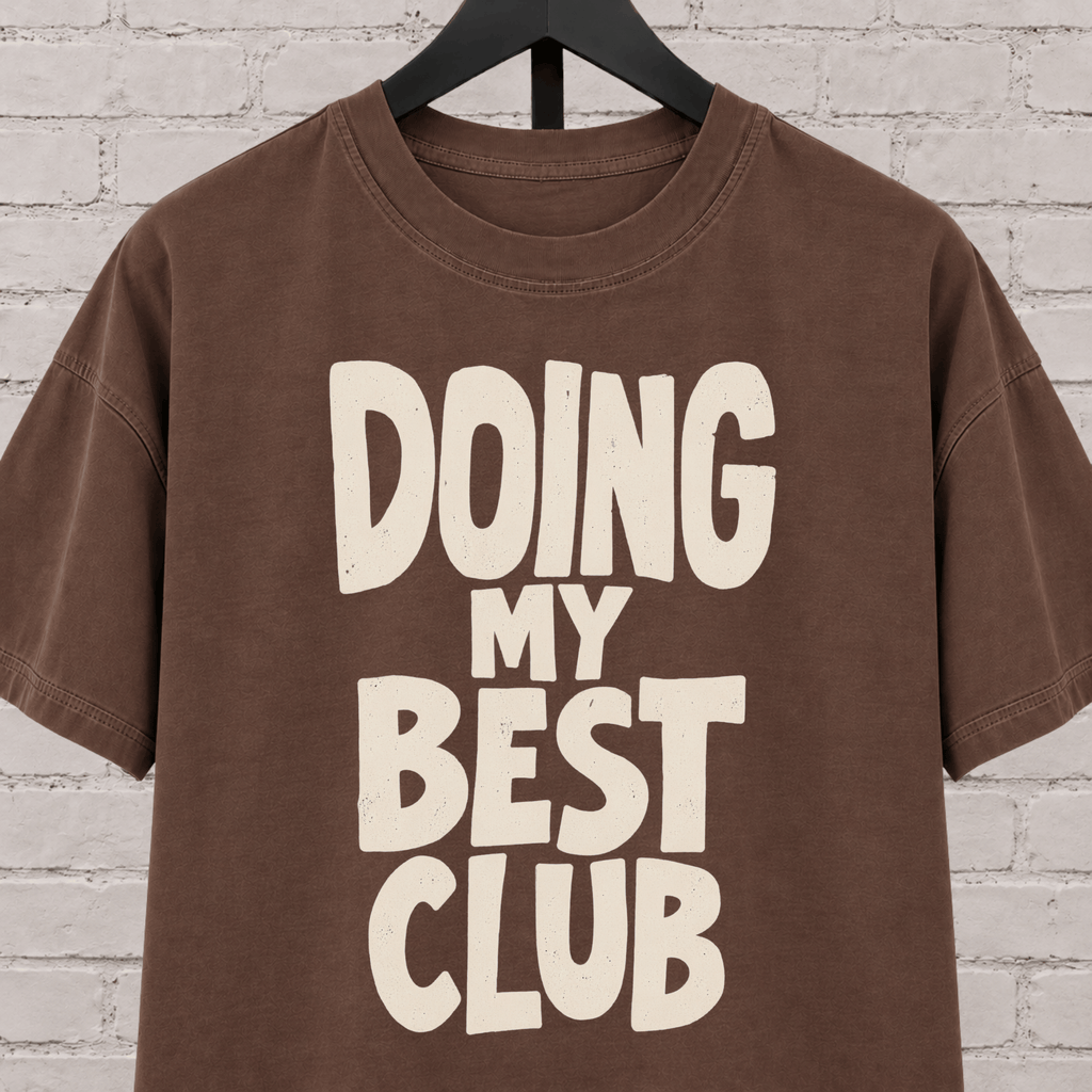 Doing My Best Club graphic T-shirt featuring bold stacked lettering, a low energy humor shirt for overwhelmed days and people running on limited bandwidth.