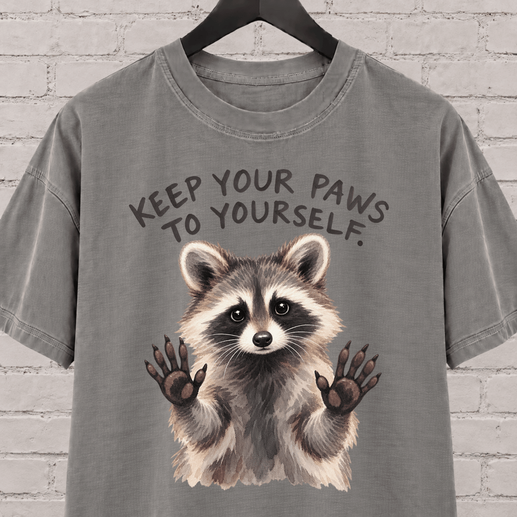 Keep Your Paws to Yourself raccoon graphic T-shirt featuring a raccoon with raised paws, an antisocial personal space shirt.