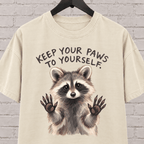Keep Your Paws to Yourself raccoon graphic T-shirt featuring a raccoon with raised paws, an antisocial personal space shirt.