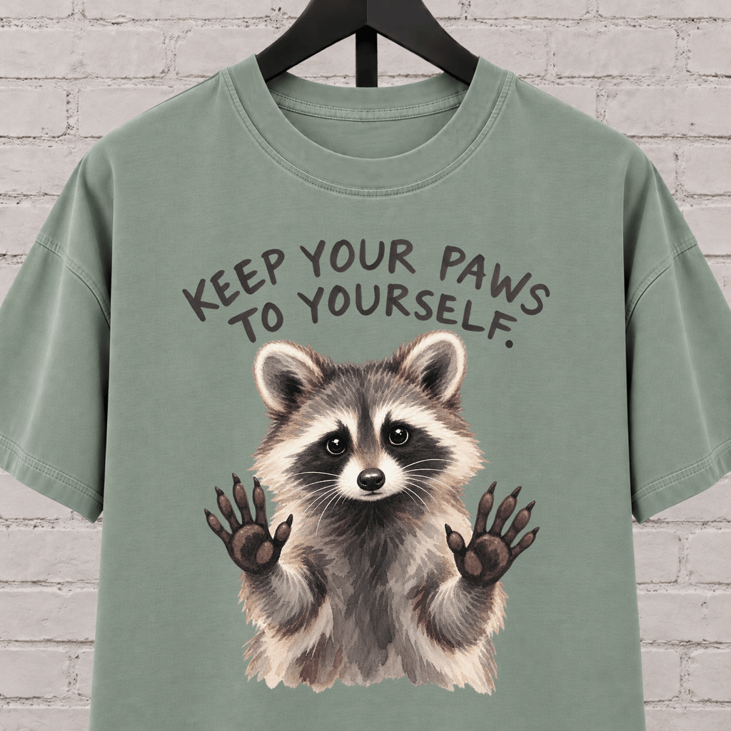 Keep Your Paws to Yourself raccoon graphic T-shirt featuring a raccoon with raised paws, an antisocial personal space shirt.