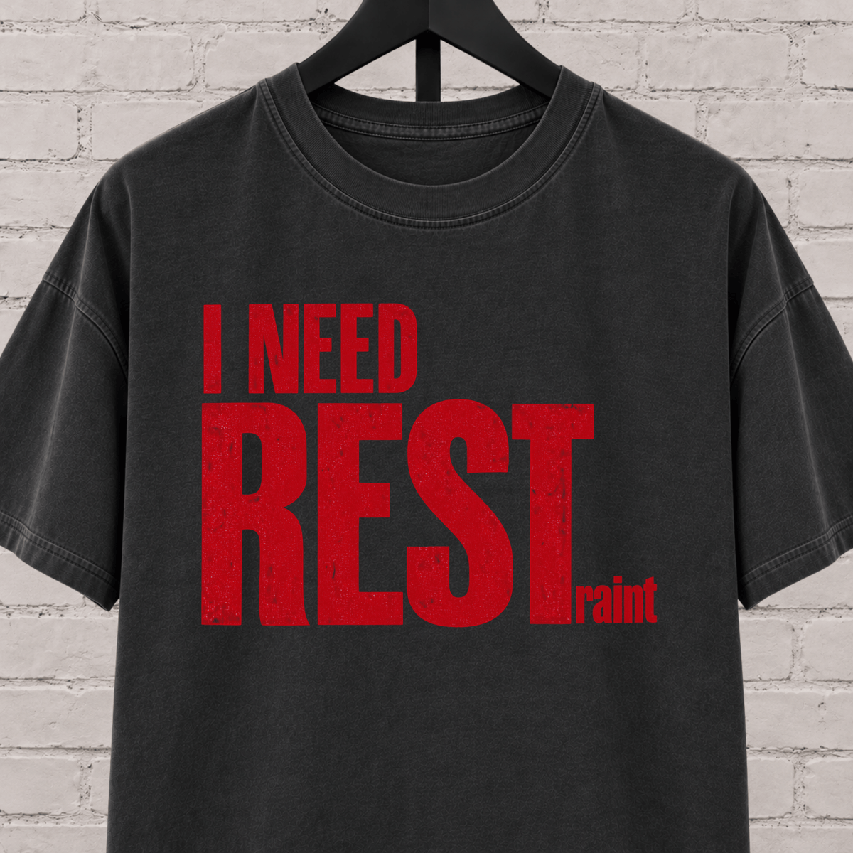 I Need Restraint graphic T-shirt featuring bold distressed lettering, an overwhelmed and overstimulated humor shirt for people who seriously need rest.