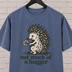 Not Much of a Hugger hedgehog T-shirt featuring a hedgehog holding a flower, an introvert personal space graphic tee.