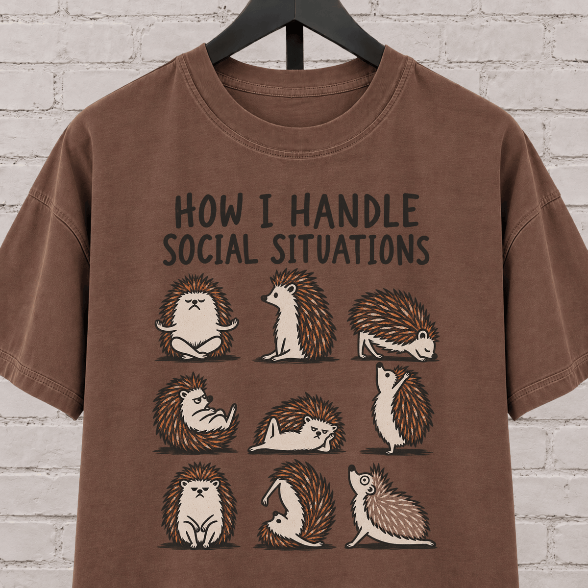 Socially awkward hedgehog graphic T-shirt featuring nine illustrated hedgehogs in different poses with the phrase “How I Handle Social Situations.”