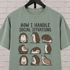 Socially awkward hedgehog graphic T-shirt featuring nine illustrated hedgehogs in different poses with the phrase “How I Handle Social Situations.”