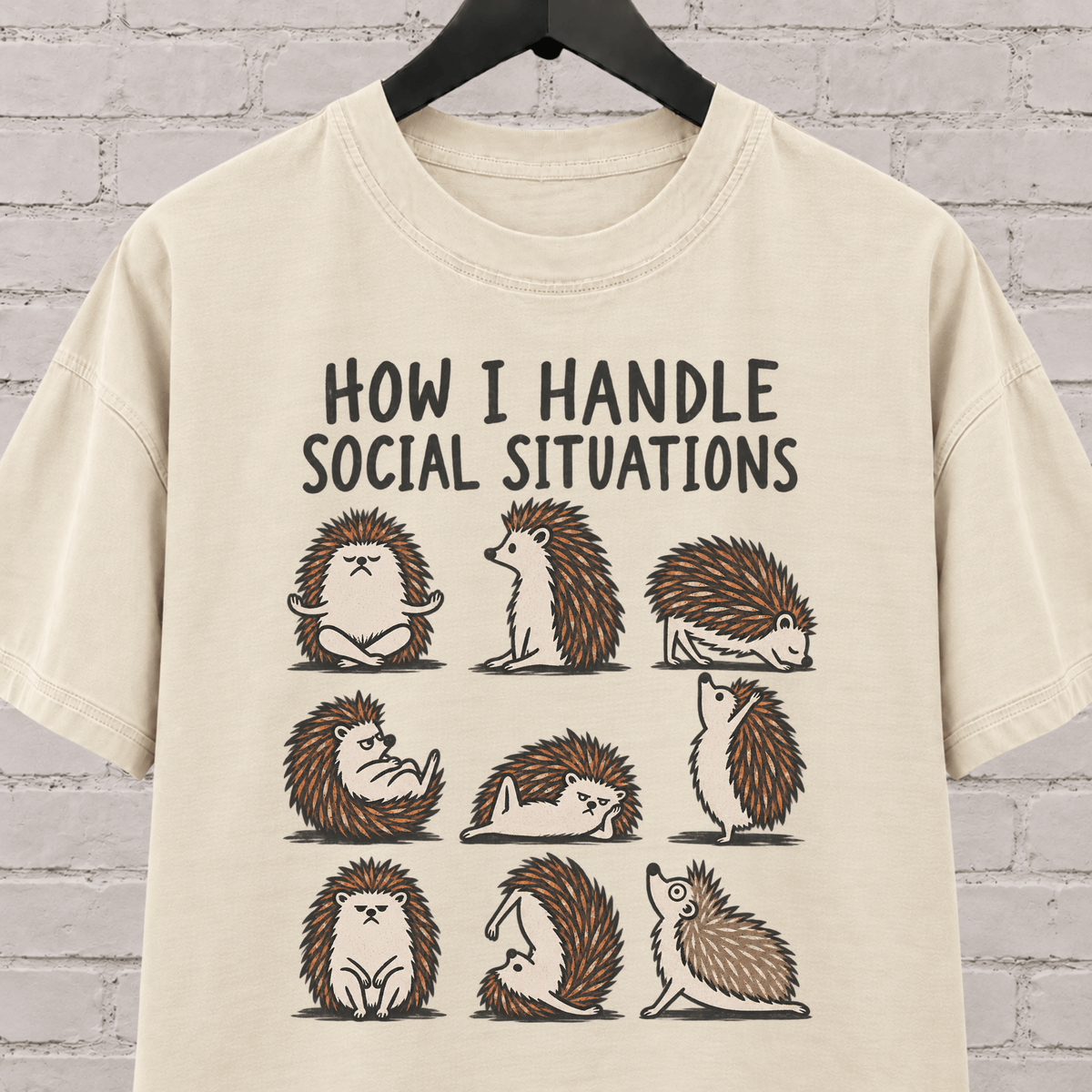 Socially awkward hedgehog graphic T-shirt featuring nine illustrated hedgehogs in different poses with the phrase “How I Handle Social Situations.”
