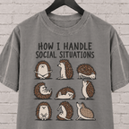 Socially awkward hedgehog graphic T-shirt featuring nine illustrated hedgehogs in different poses with the phrase “How I Handle Social Situations.”