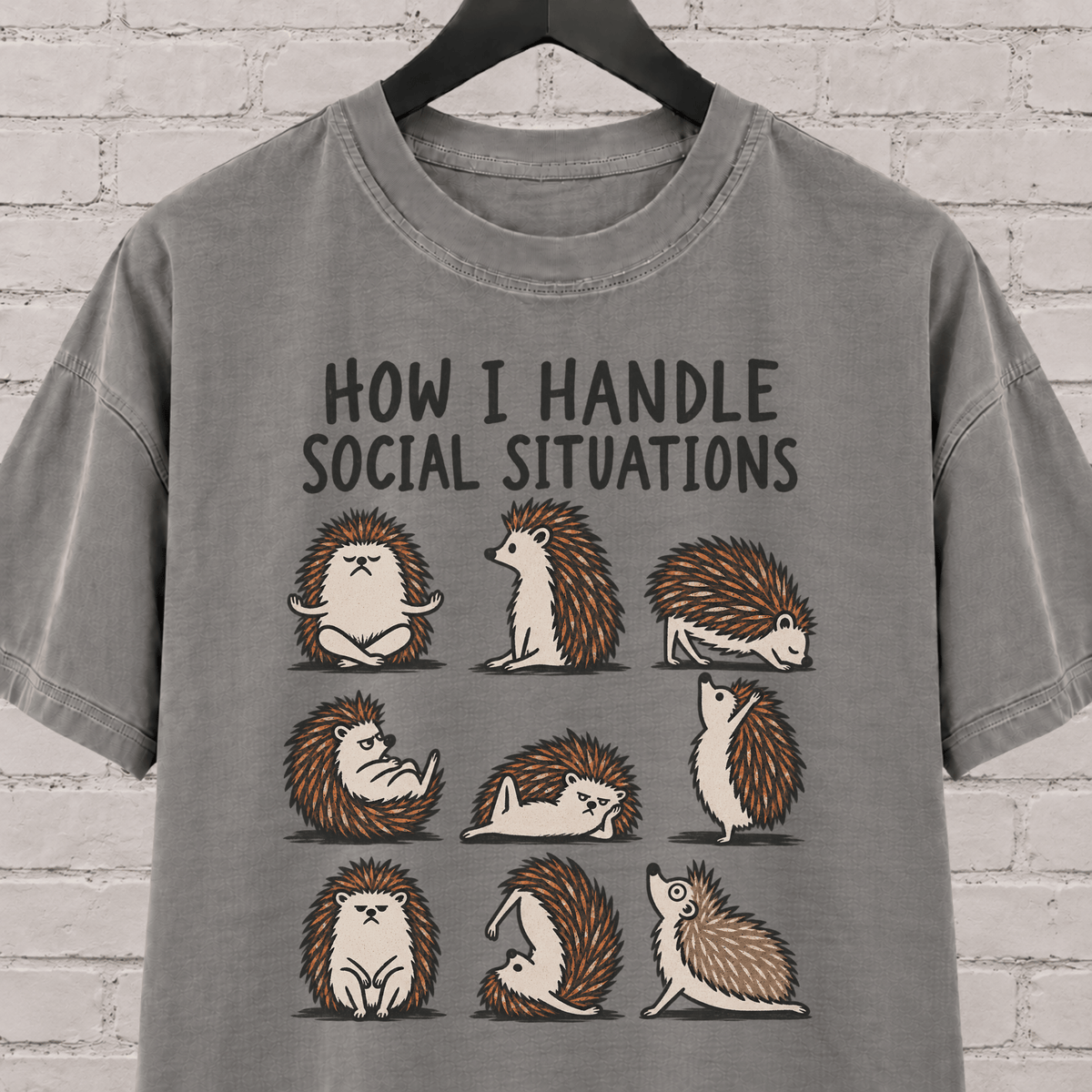 Socially awkward hedgehog graphic T-shirt featuring nine illustrated hedgehogs in different poses with the phrase “How I Handle Social Situations.”