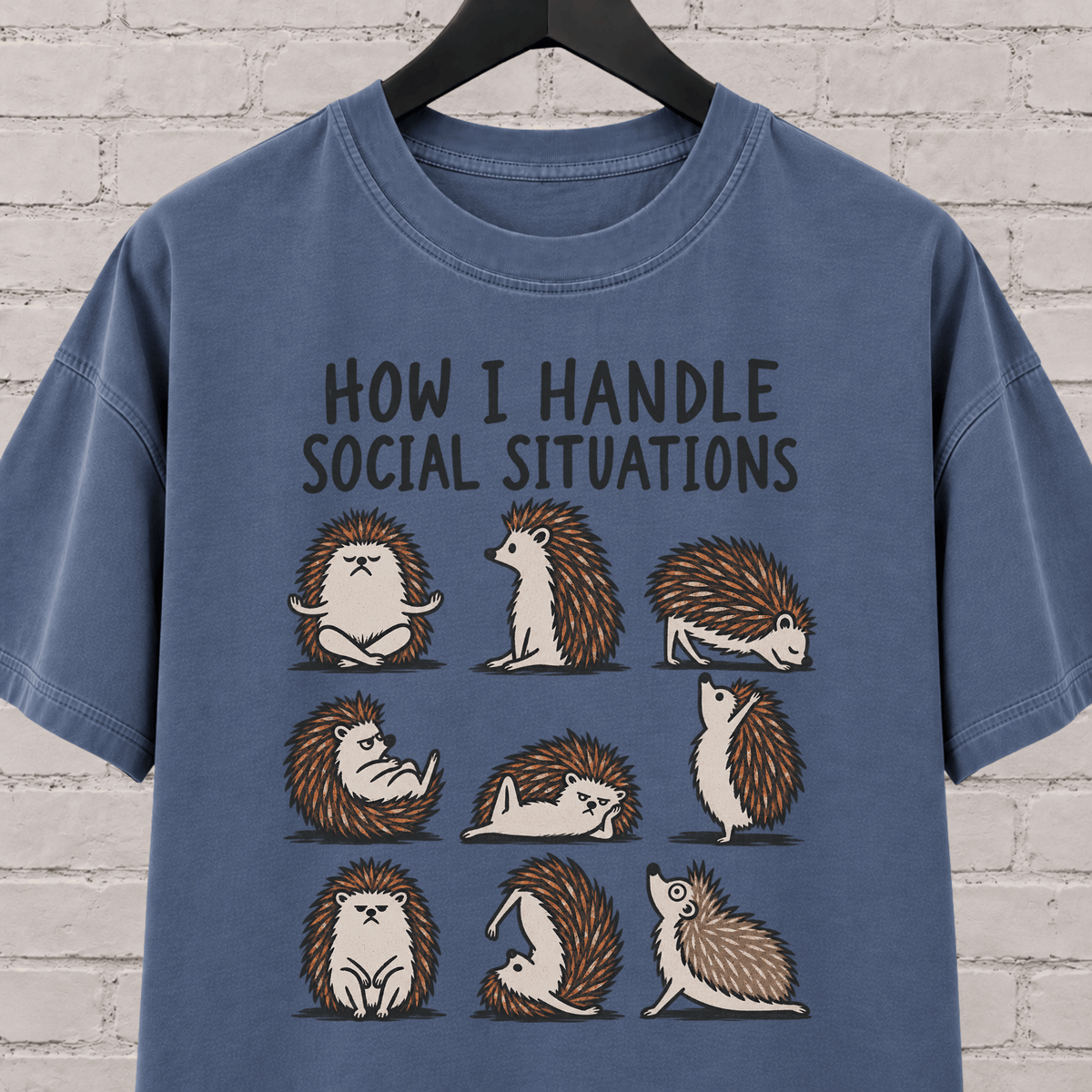 Socially awkward hedgehog graphic T-shirt featuring nine illustrated hedgehogs in different poses with the phrase “How I Handle Social Situations.”