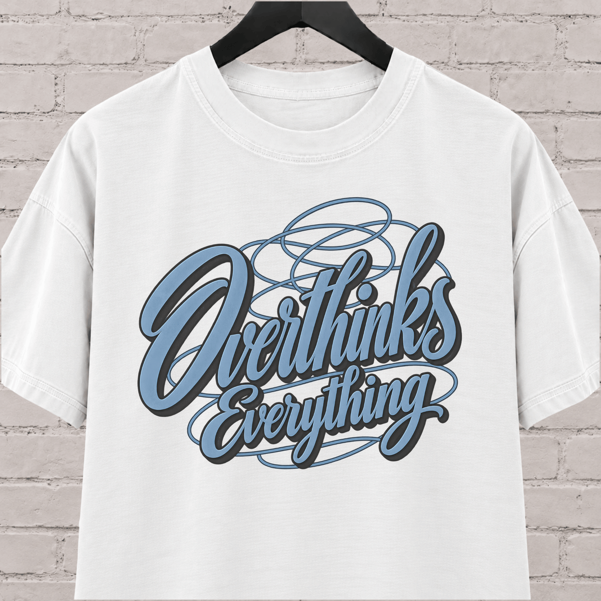 Overthinks Everything graphic T-shirt featuring layered script lettering, an overthinker shirt for people who replay conversations and overanalyze everything.