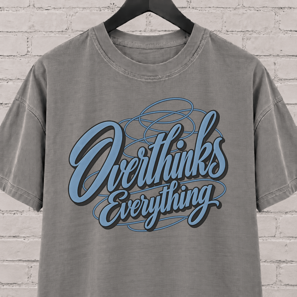 Overthinks Everything graphic T-shirt featuring layered script lettering, an overthinker shirt for people who replay conversations and overanalyze everything.