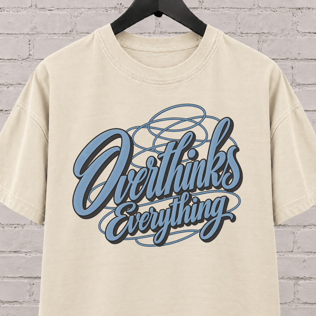 Overthinks Everything graphic T-shirt featuring layered script lettering, an overthinker shirt for people who replay conversations and overanalyze everything.