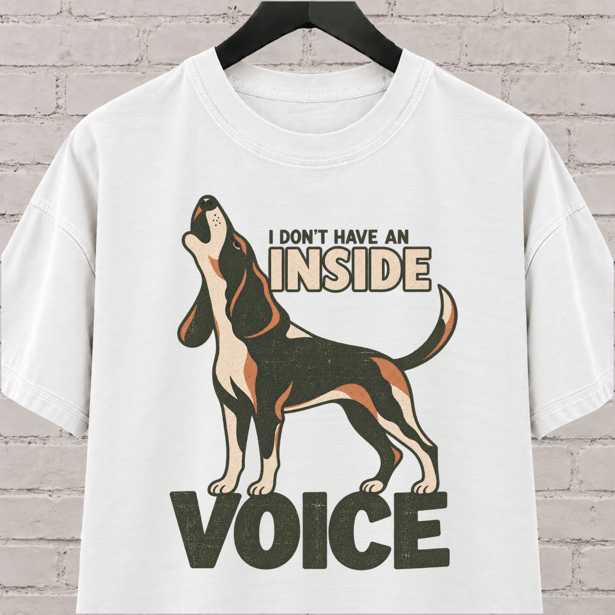Hound dog graphic T-shirt featuring a howling tricolor hound and the phrase “I Don’t Have an Inside Voice,” a dog lover shirt with loud dog humor.