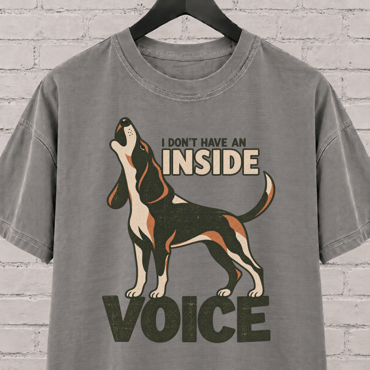 Hound dog graphic T-shirt featuring a howling tricolor hound and the phrase “I Don’t Have an Inside Voice,” a dog lover shirt with loud dog humor.