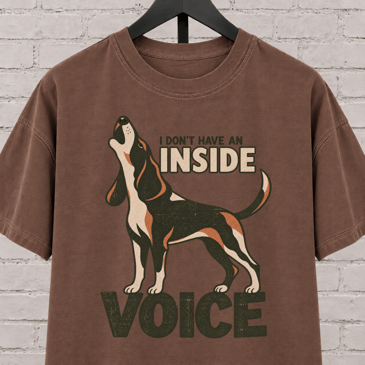 Hound dog graphic T-shirt featuring a howling tricolor hound and the phrase “I Don’t Have an Inside Voice,” a dog lover shirt with loud dog humor.