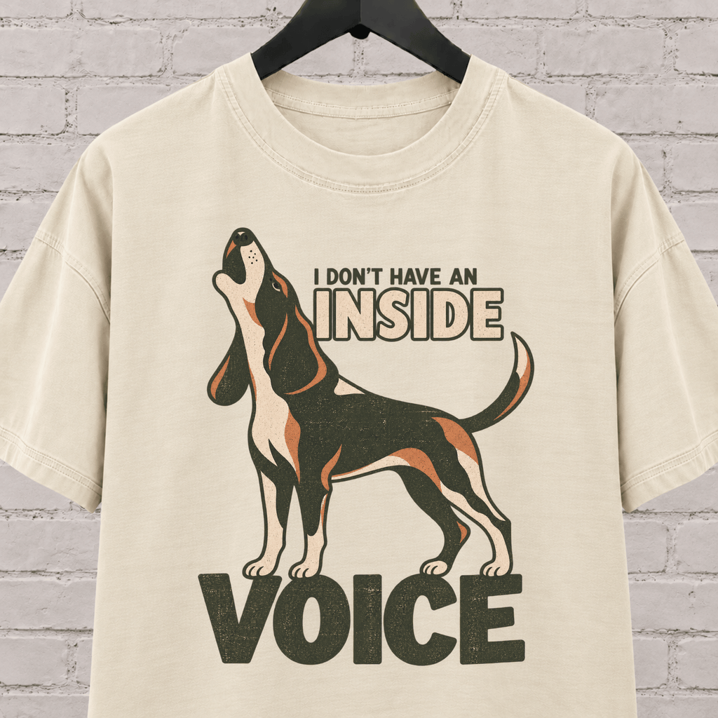 Hound dog graphic T-shirt featuring a howling tricolor hound and the phrase “I Don’t Have an Inside Voice,” a dog lover shirt with loud dog humor.