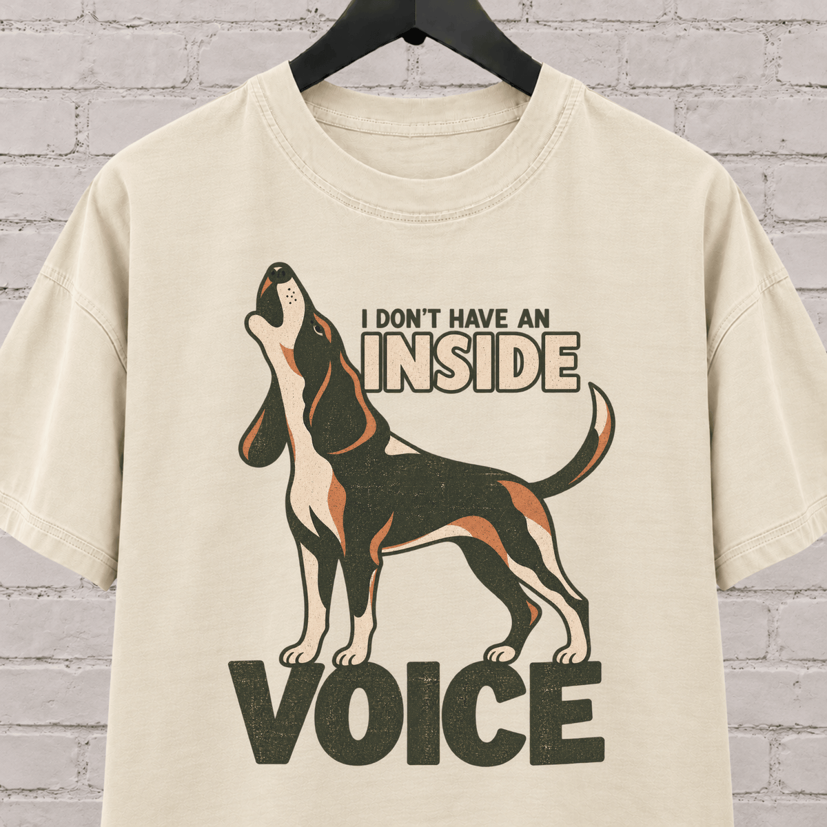 Hound dog graphic T-shirt featuring a howling tricolor hound and the phrase “I Don’t Have an Inside Voice,” a dog lover shirt with loud dog humor.