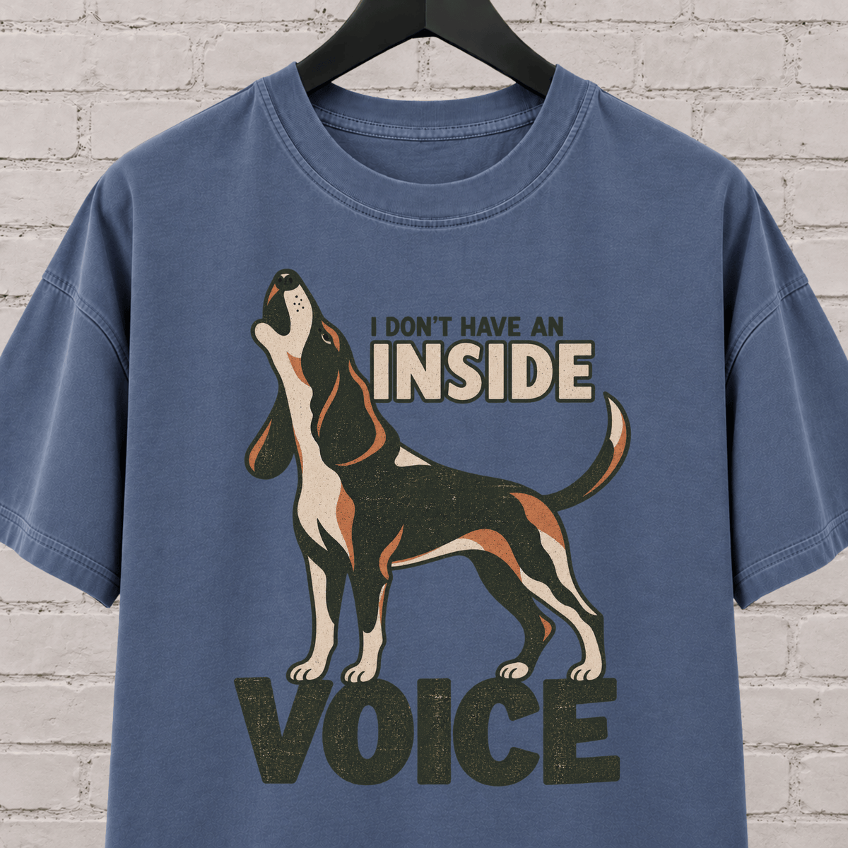 Hound dog graphic T-shirt featuring a howling tricolor hound and the phrase “I Don’t Have an Inside Voice,” a dog lover shirt with loud dog humor.